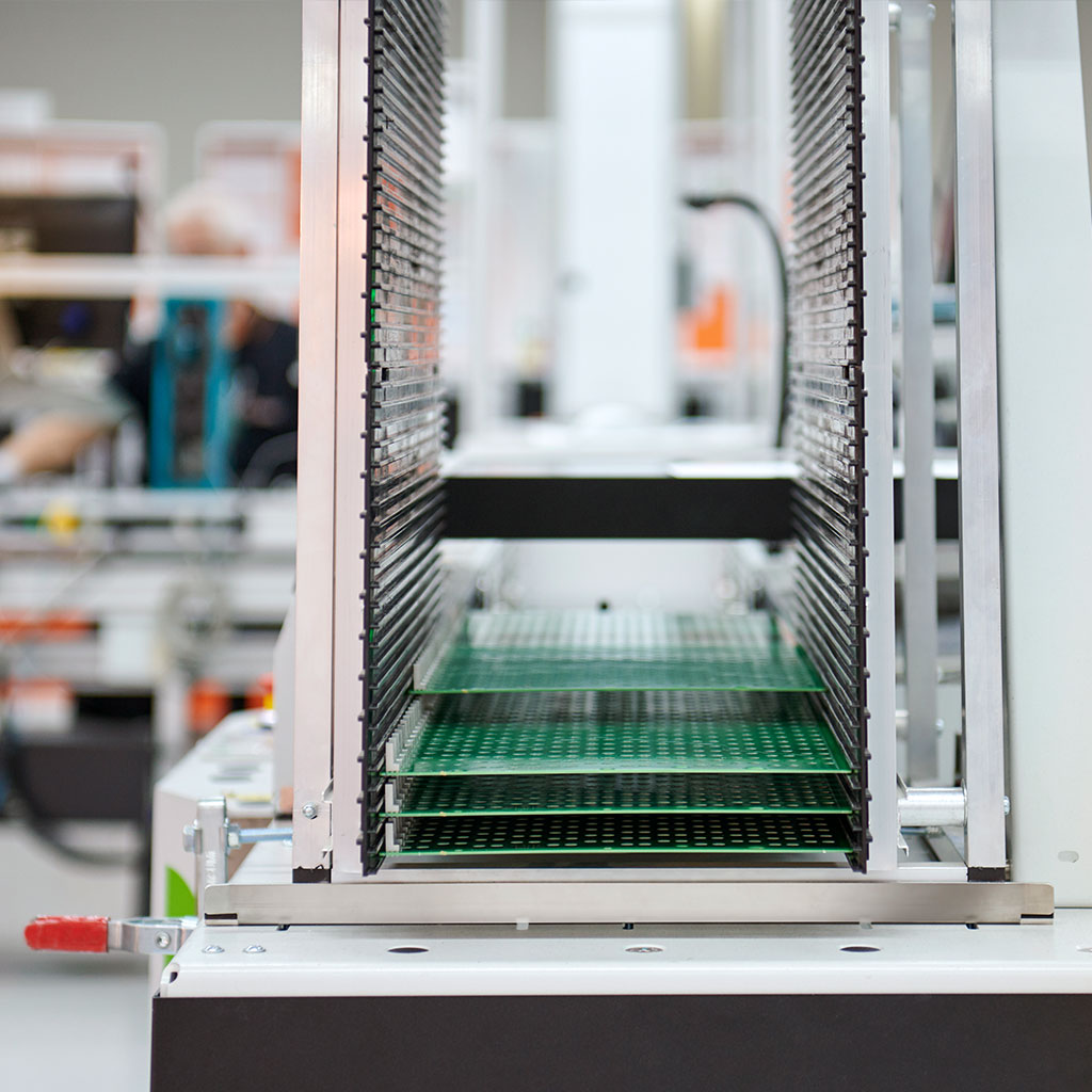 Production facility with stacked printed circuit boards in the magazine